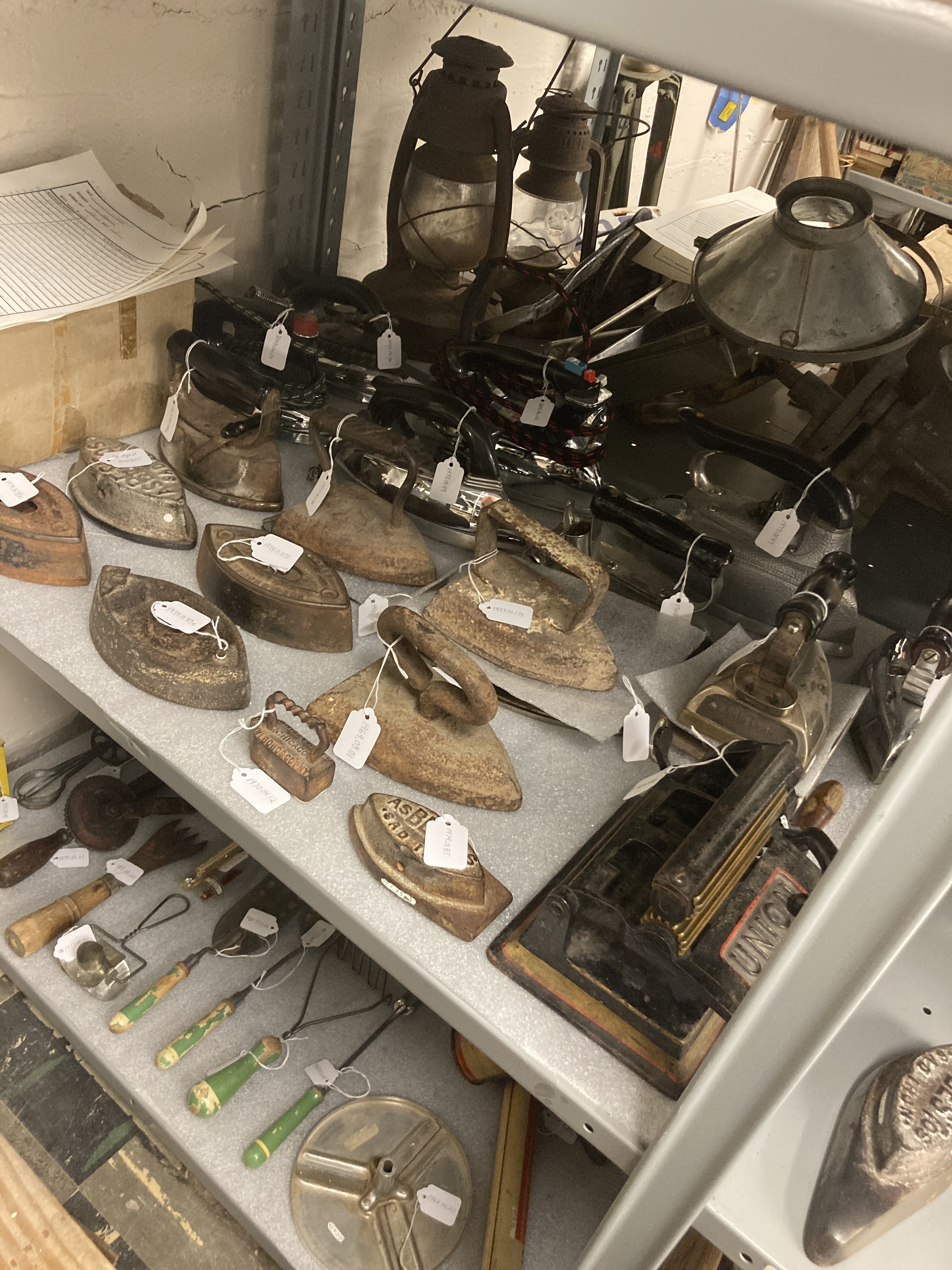 Shelf in storage full of historical irons