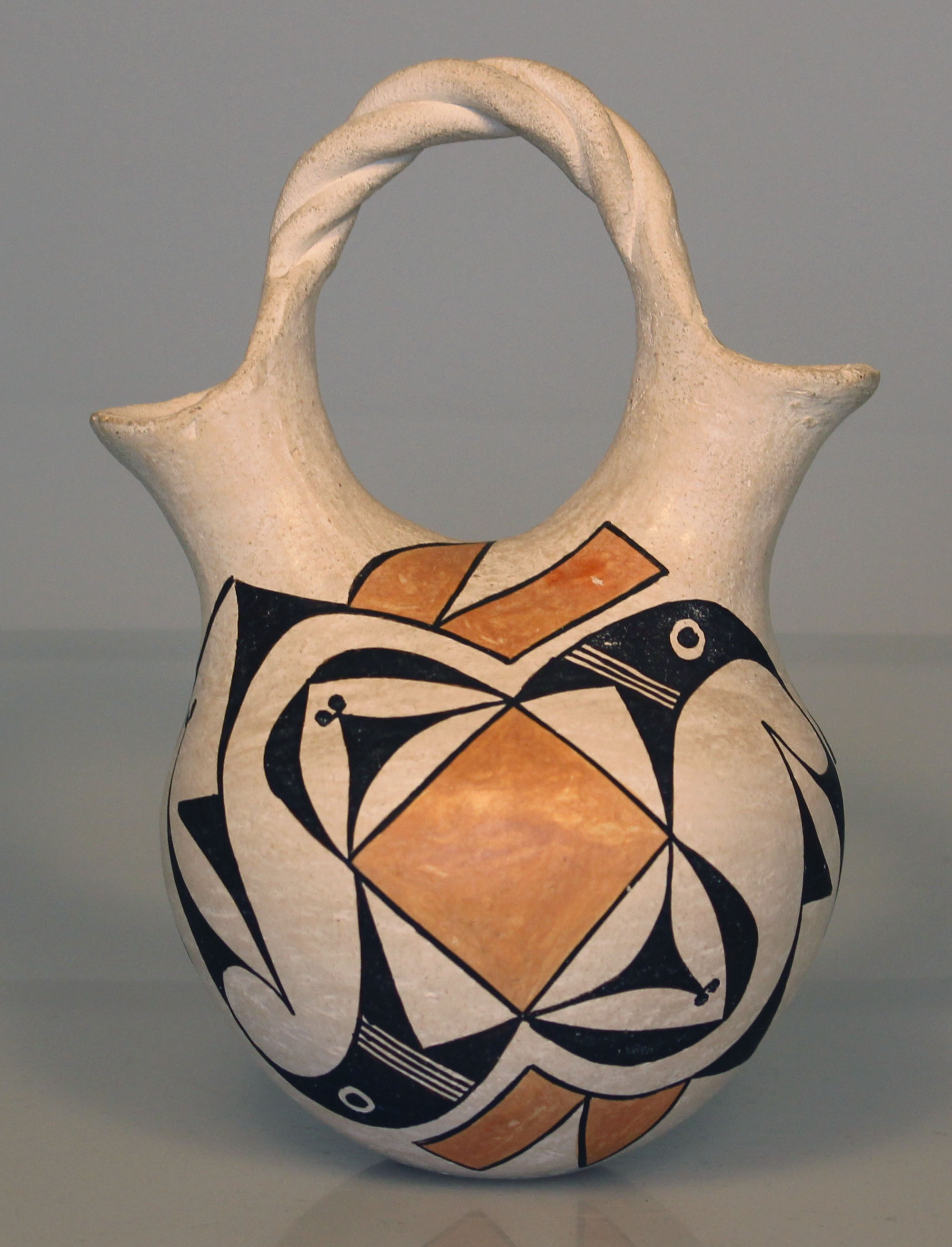 Wedding vase by Lucy Lewis, white with geometric black and orange designs.