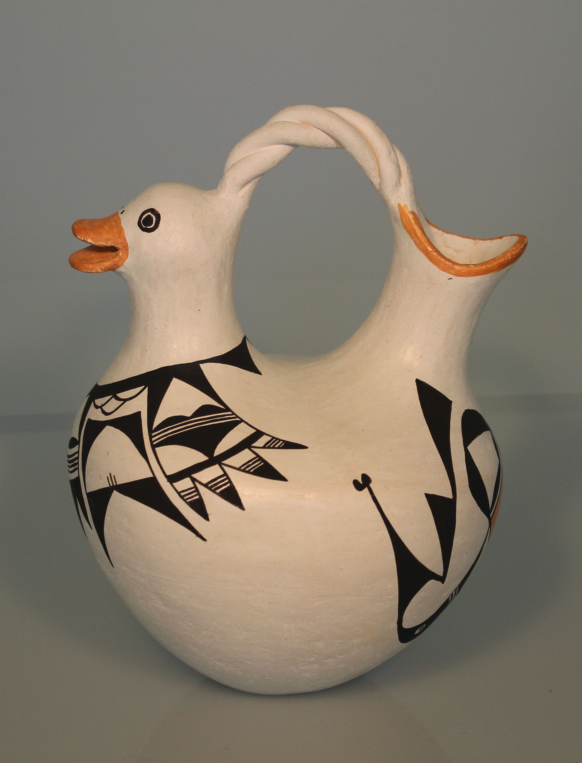 Wedding vase with chicken head by Lucy Lewis, white with geometric black and orange designs.