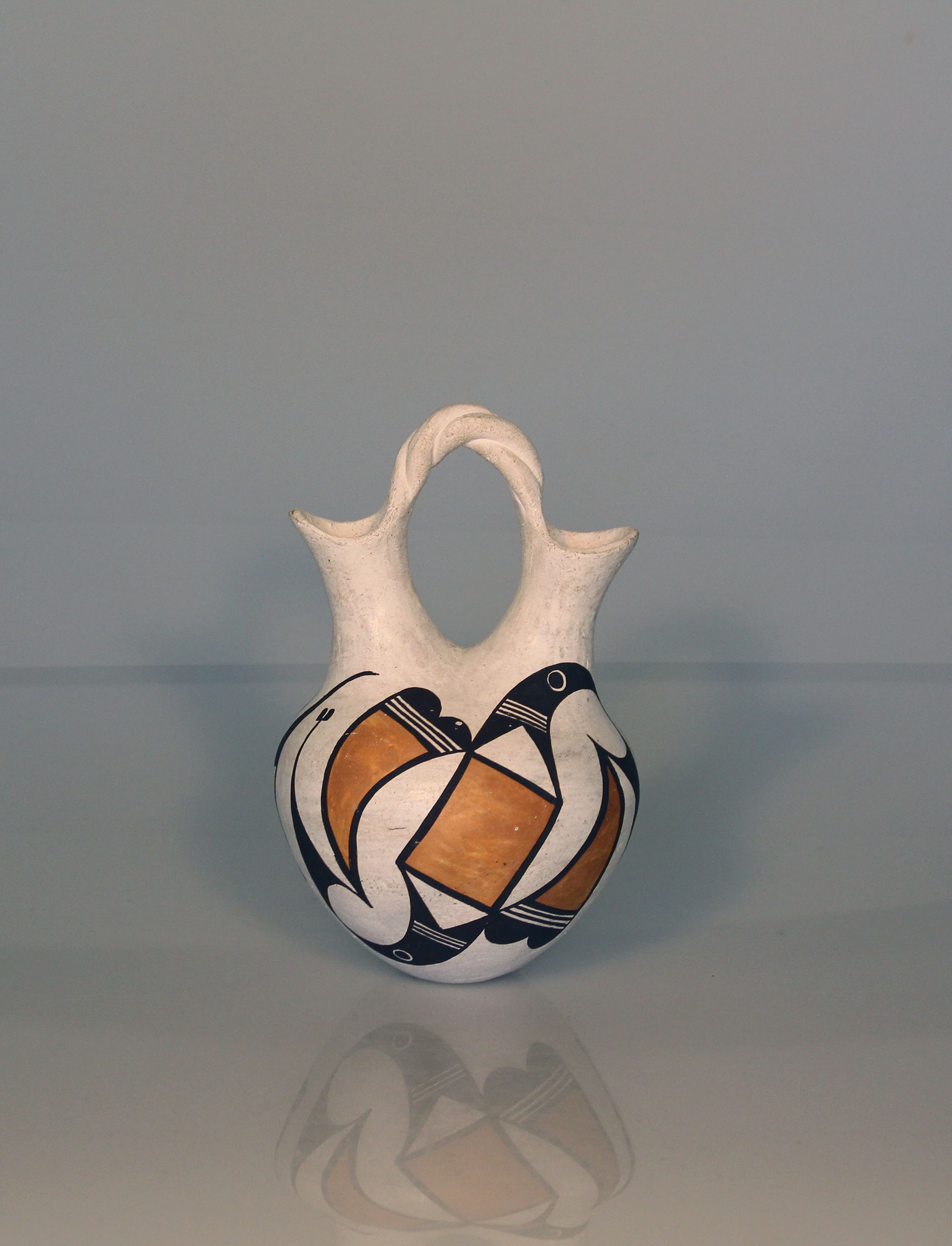 Wedding vase by Lucy Lewis, white with geometric black and orange designs.