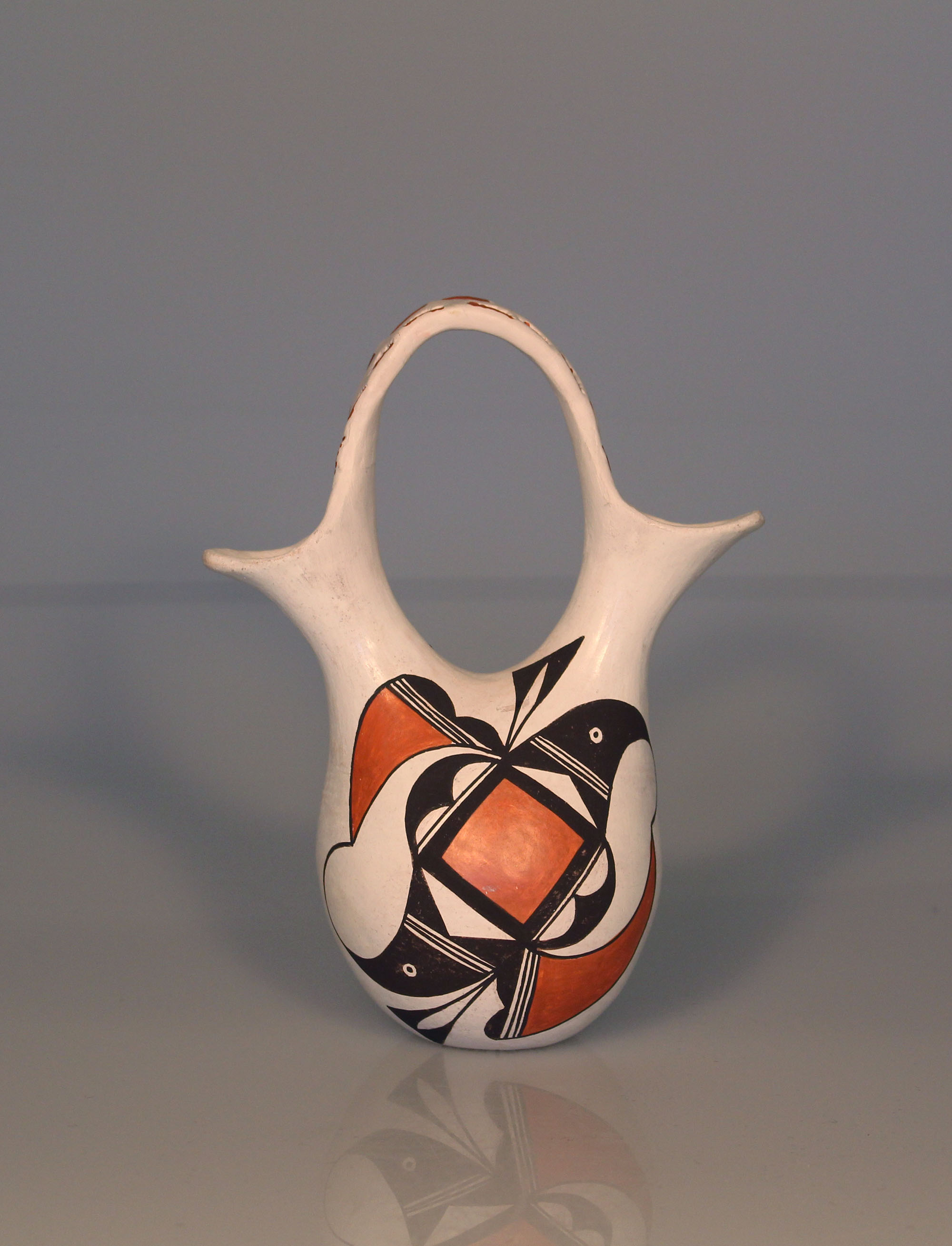 Wedding vase by Mary D. (Lewis Histia) Garcia, Lucy Lewis' daughter. White with orange and black designs. 