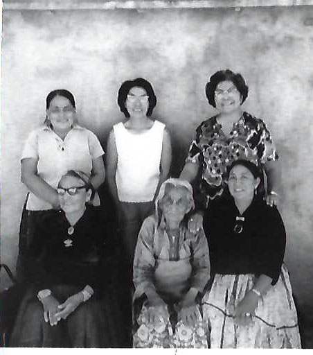 Tall woman an her daughters outside Augusta's house.